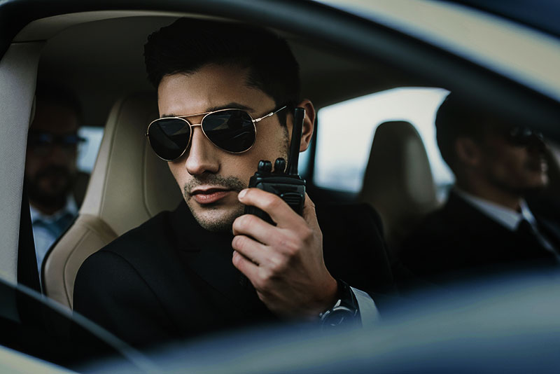 bodyguard-in-sunglasses-talking-by-portable-radio-resize.jpg